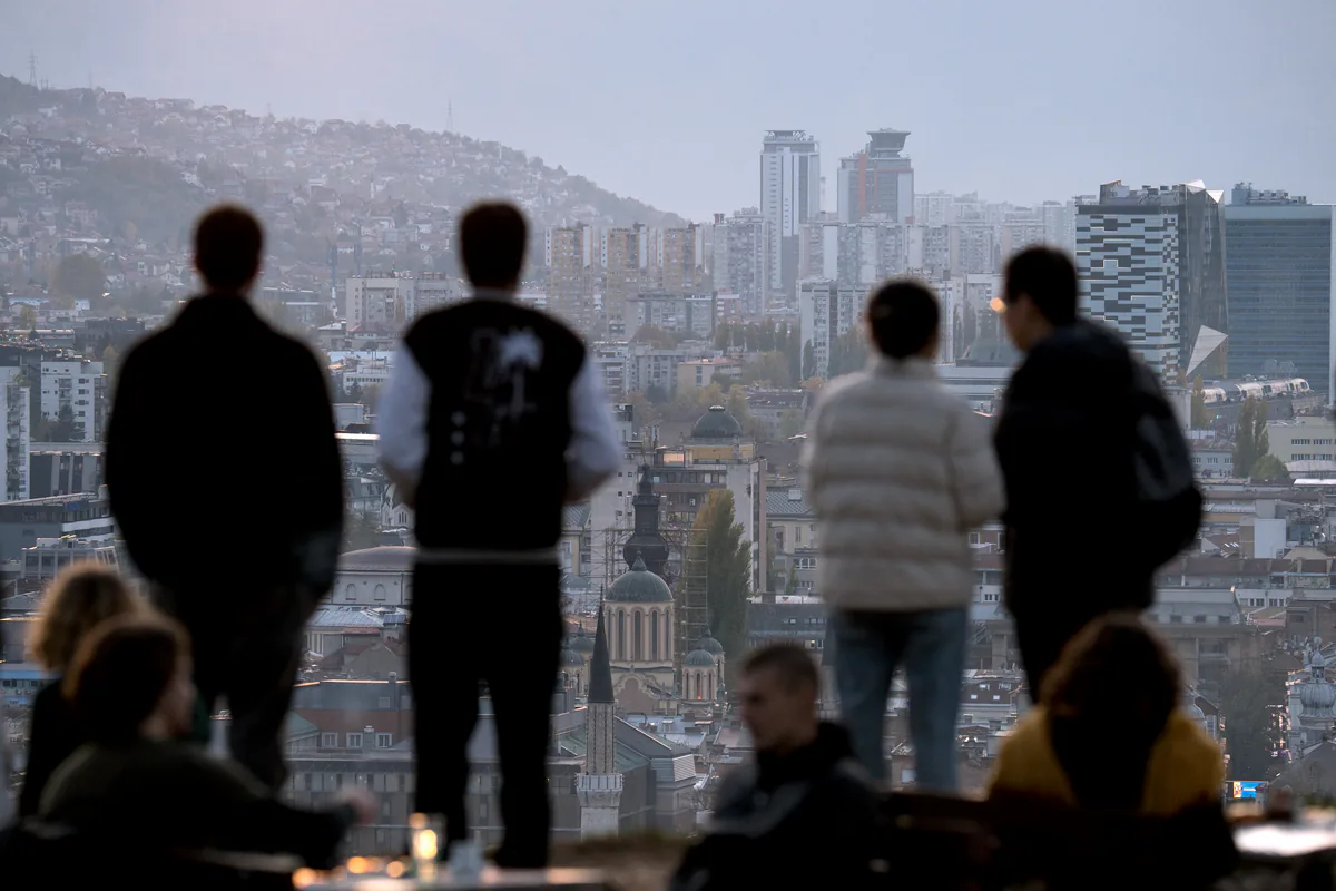 Locals as well as tourists observe sunset from "Zuta Tabija" vantage point, overlooking the city valley of Sarajevo.